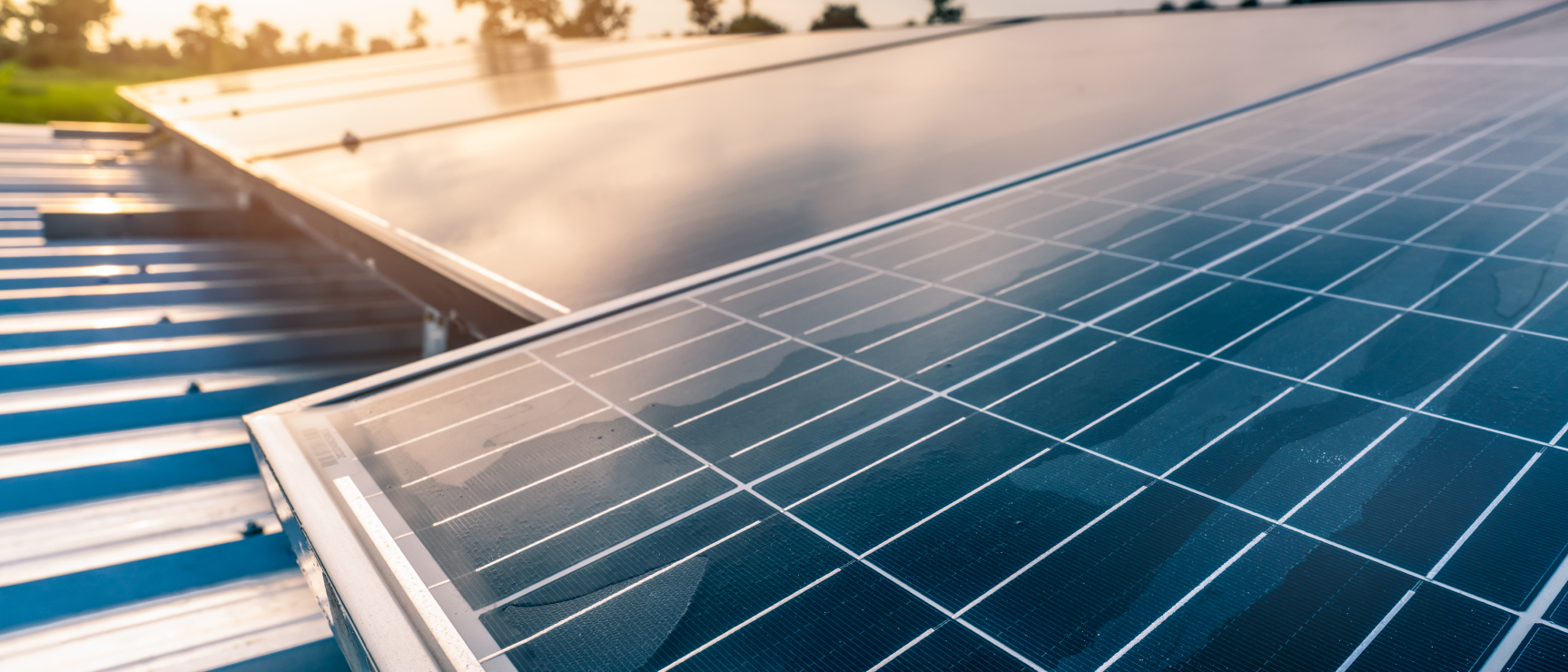 Commercial solar panels installed on a metal rooftop, close-up view