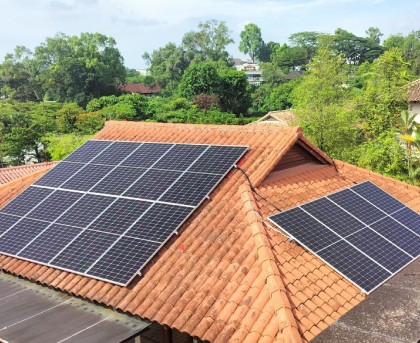 Residential solar panels installed on a home's terracotta tile roof in a landed property.