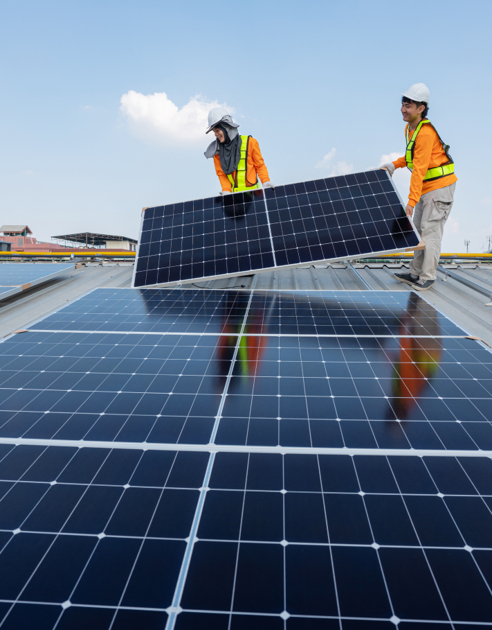 Technicians performing solar panel installation on a rooftop in Singapore