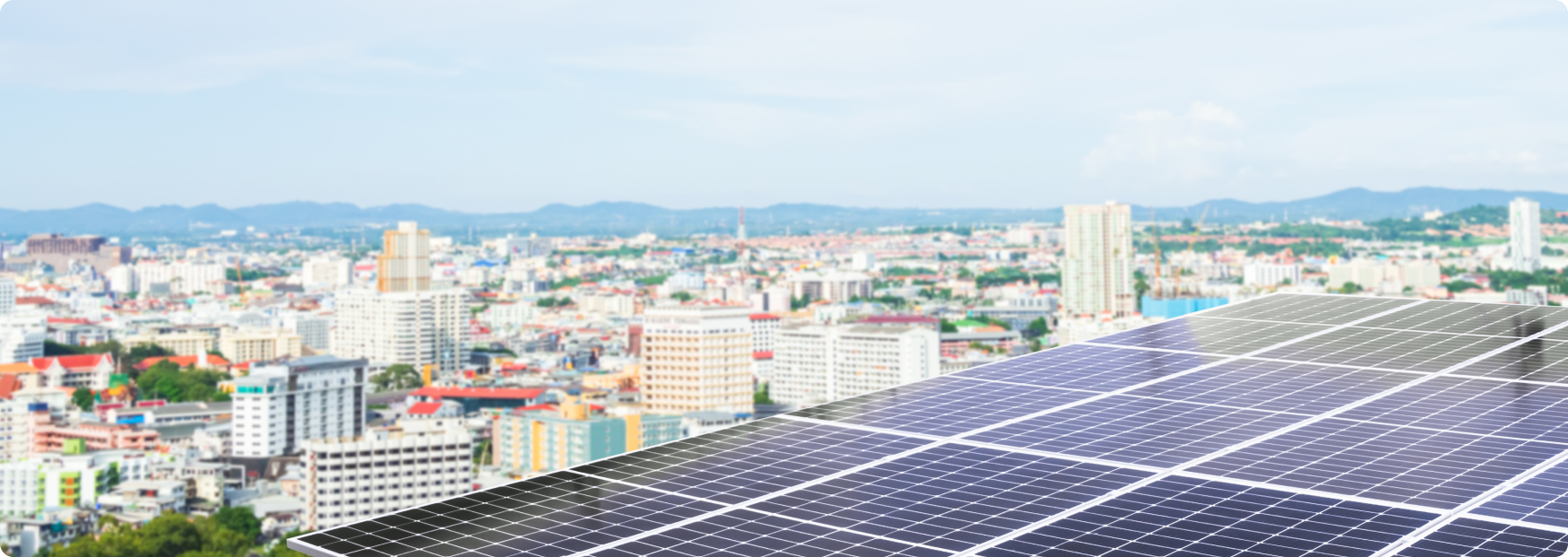 Solar panel system installed on a rooftop overlooking the Singapore city skyline